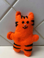 A small orange felt tiger with black stripes.